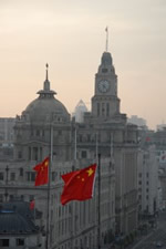 Berkeley Lab researchers challenge conventional wisdom about China's energy consumption. A towered building in China with national Chinese flags in the foreground