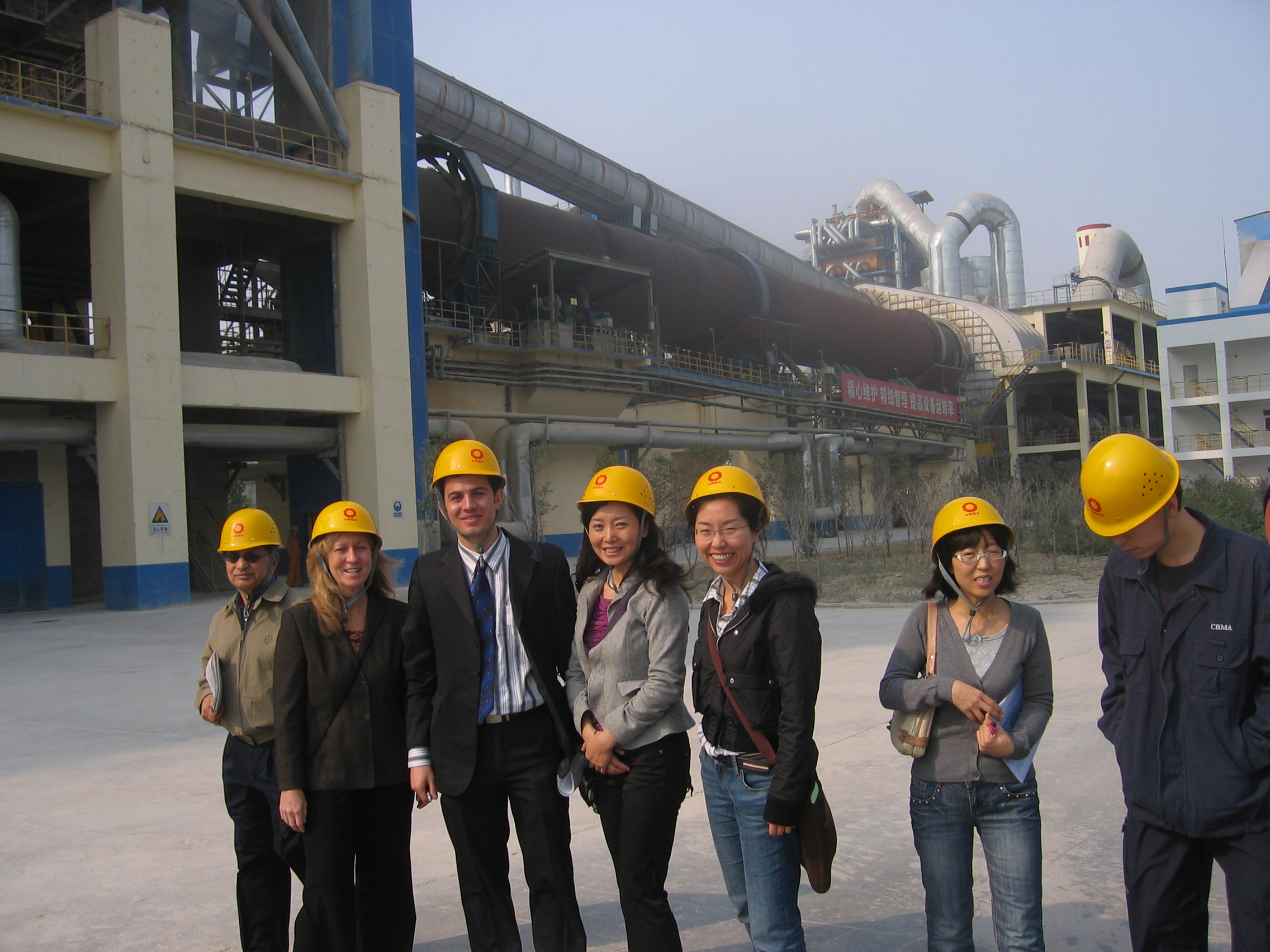 China Energy Group members Lynn Price, Ali Hasanbeigi, Nan Zhou and Hongyou Lu visit a Chinese cement factory to train staff in energy efficiency measures. Photo of China Energy Group members at a Chinese cement factory